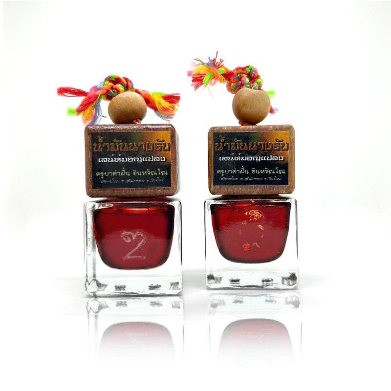 Namman Nang Rab spiritual oil in two decorative bottles for enhancing feng shui and spiritual practices