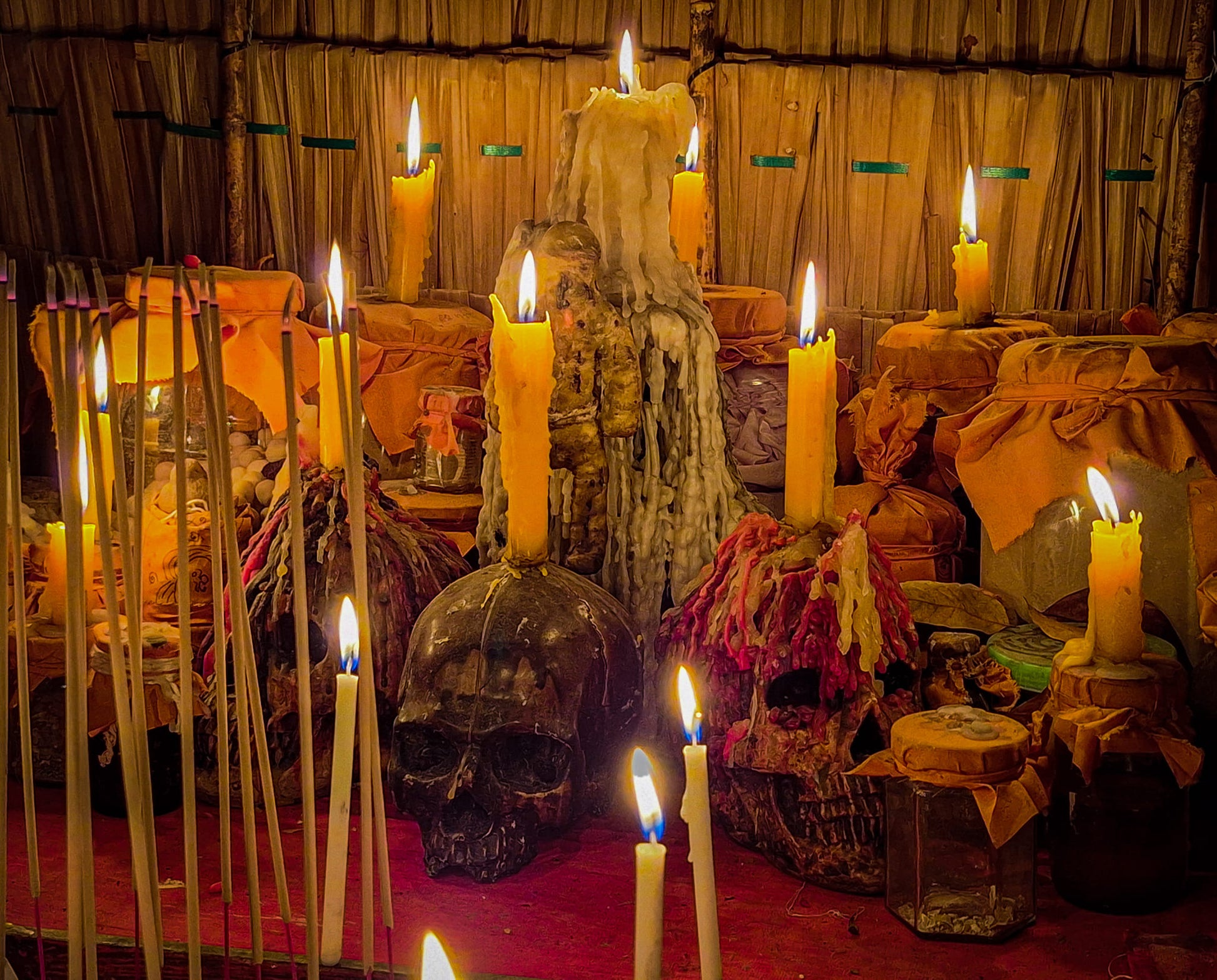 Namman Prai balm for spiritual power displayed on ritual altar with lit candles skulls incense and offerings
