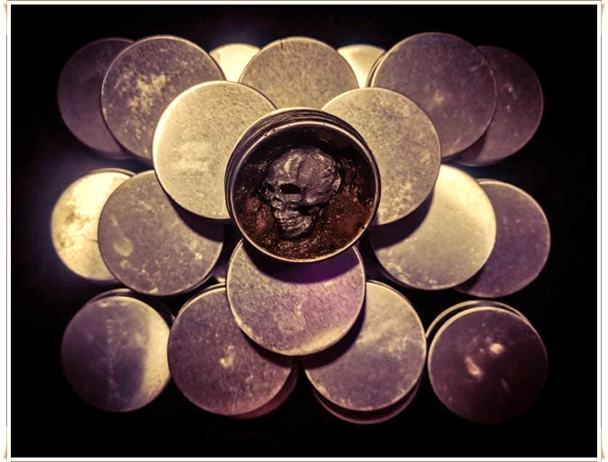 Thai Blessing Co Namman Prai balm for spiritual power in metal tins with an open jar showing skull