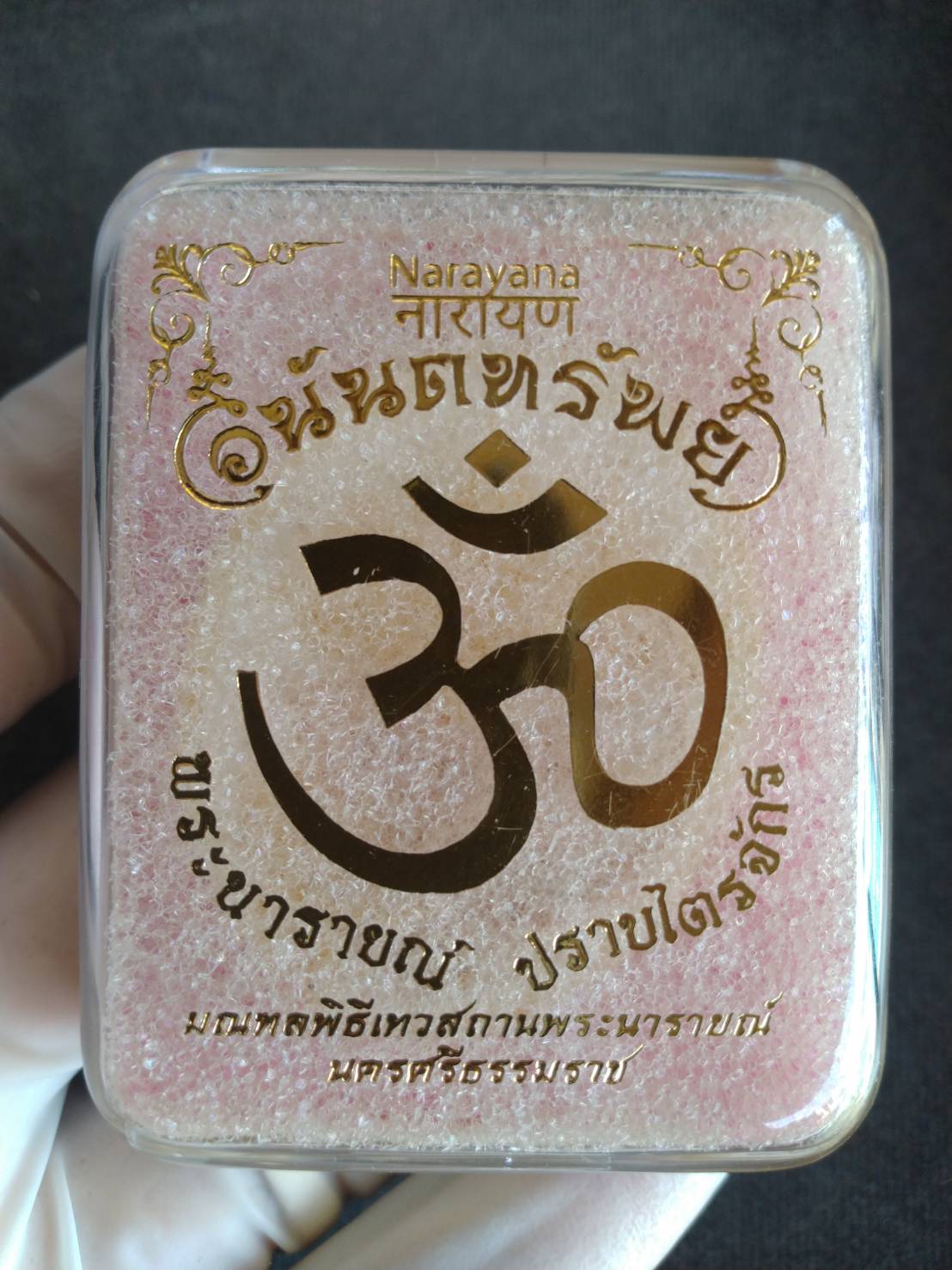 authentic Thai Narai lucky charm in clear pink box with gold Om symbol and Thai blessing text by Thai Blessing Co