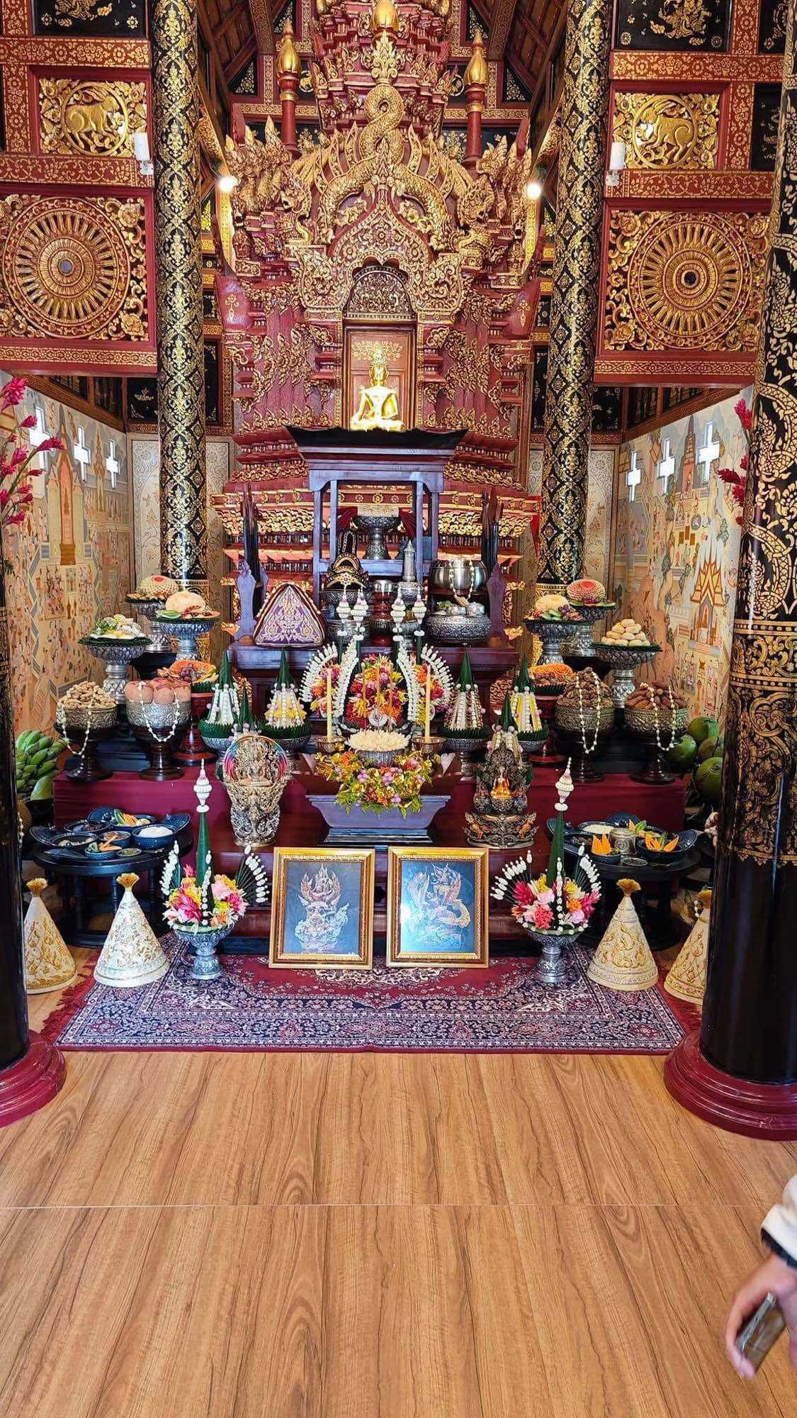 Narayana on Garuda amulet displayed in a beautifully decorated Thai altar with intricate designs