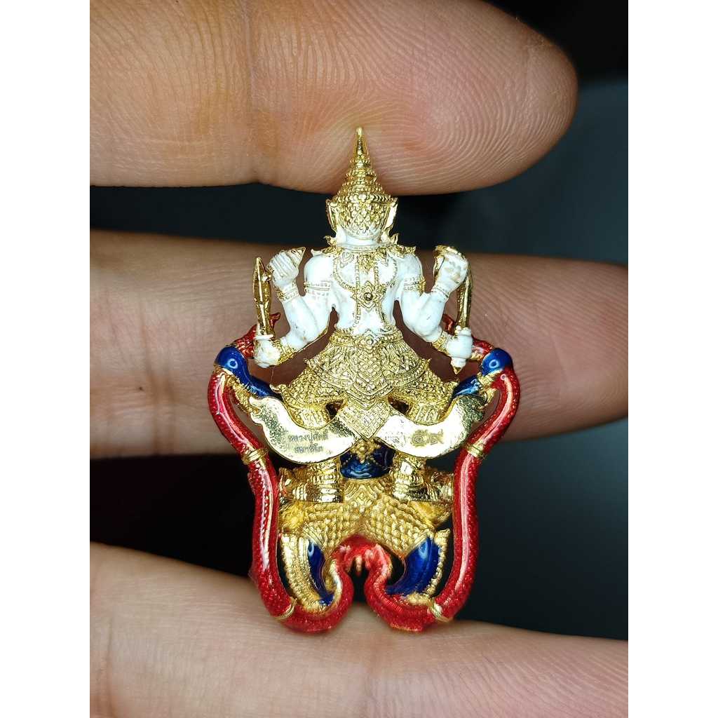 Narayana on Garuda amulet held between fingers with gold white red and blue colors by Thai Blessing Co
