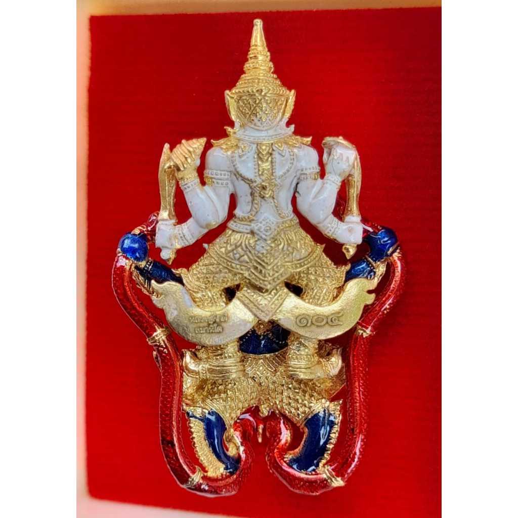 Narayana on Garuda amulet with gold, white, red, and blue details on a red background