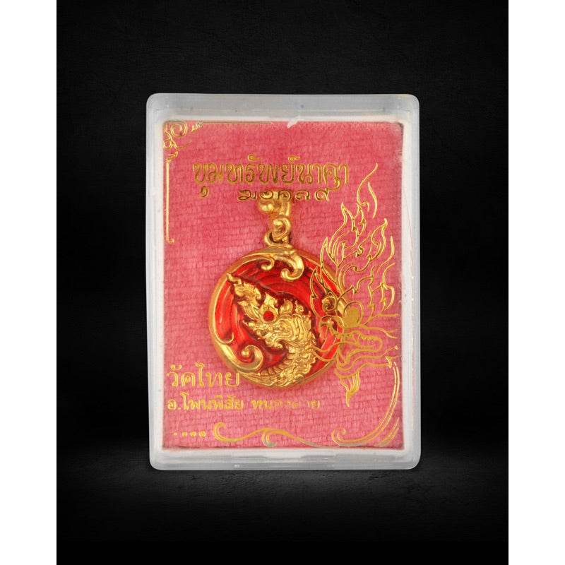 Naga treasure amulet Thailand gold red circular naga pendant in clear plastic case on red Thai script card