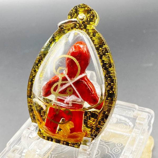 Oil-wrapped spirit doll for protection in a gold and black pendant frame by Thai Blessing Co