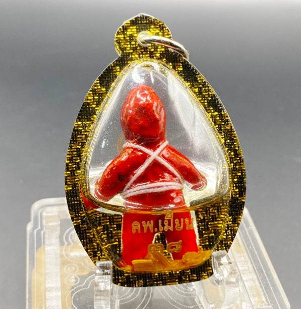 Thai Blessing Co oil-wrapped spirit doll for protection with red figure encased in decorative gold and black frame
