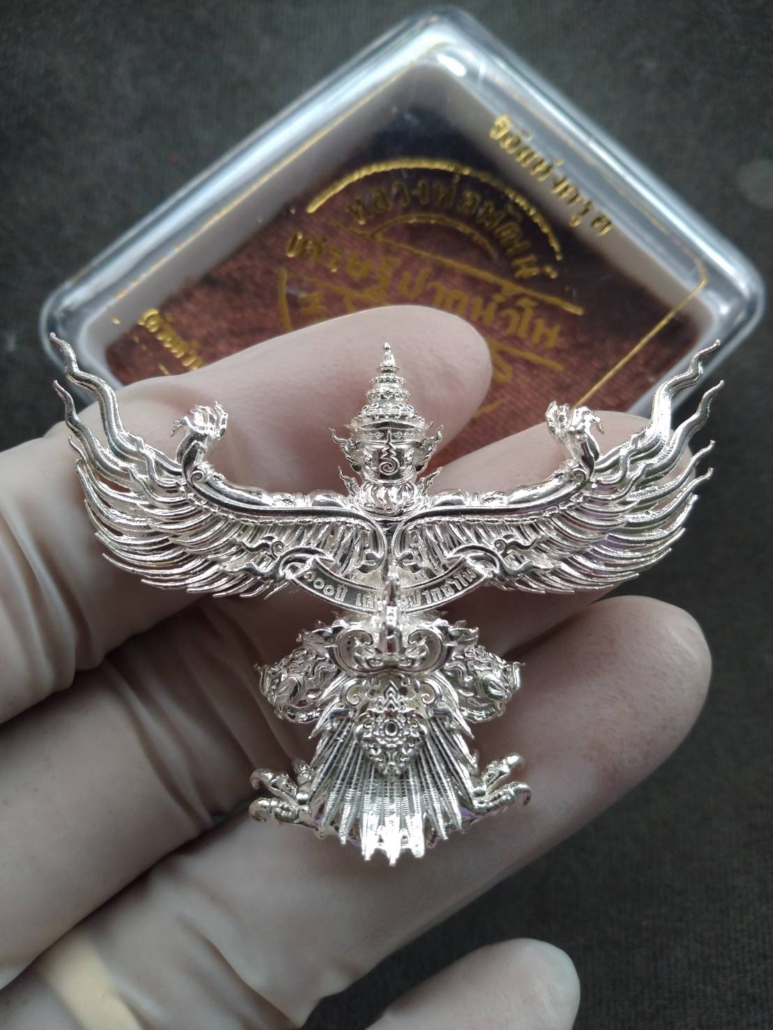Thai Garuda Pak Nam Pho Tycoon edition silver Garuda pendant held in hand with ornate wings and details