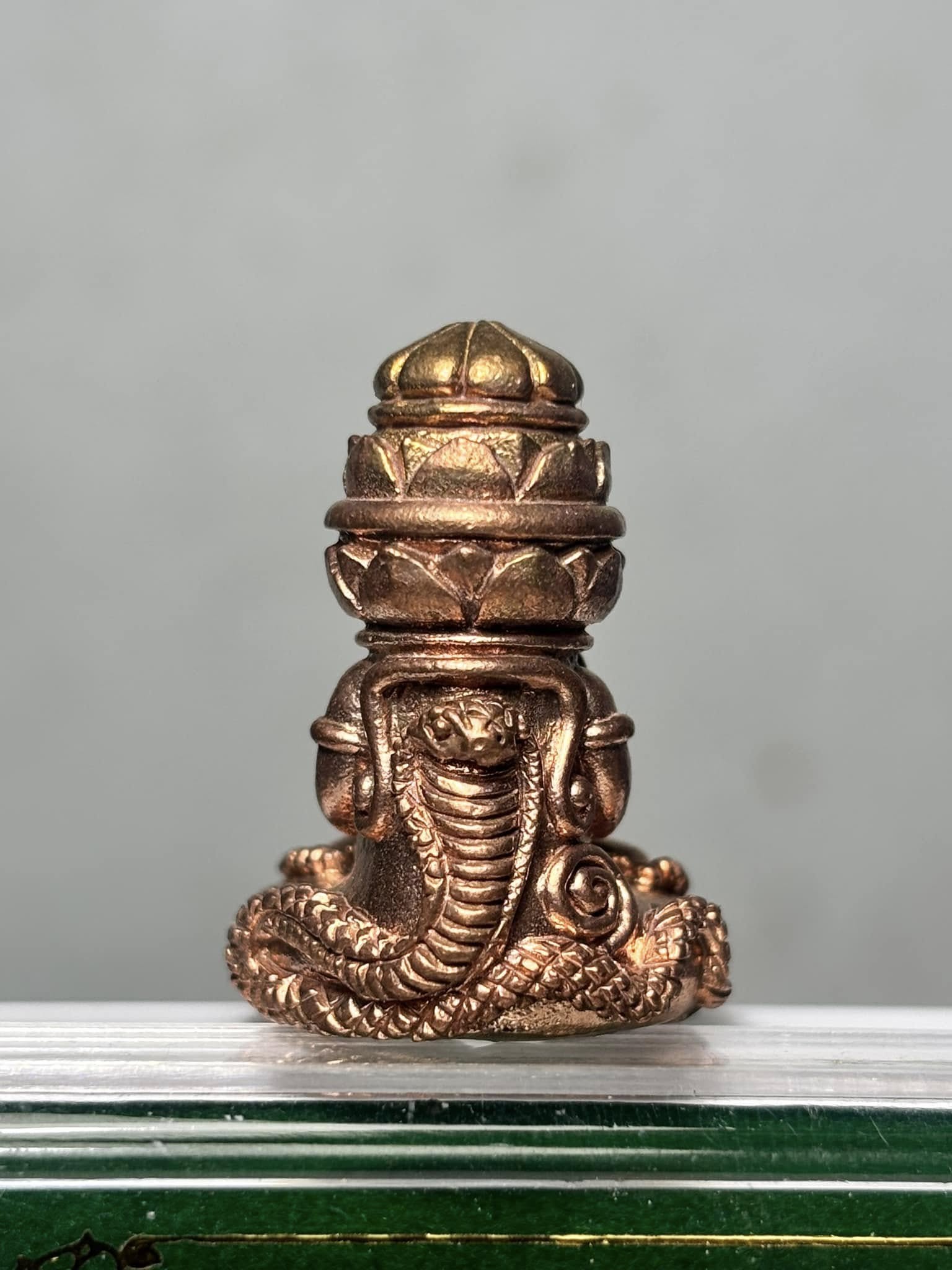 Phang Phakhan amulet for good fortune, intricately designed with a snake motif and golden details