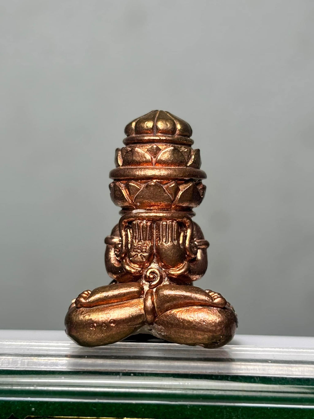 Phang Phakhan amulet for good fortune in bronze finish, featuring intricate detailing and a seated design