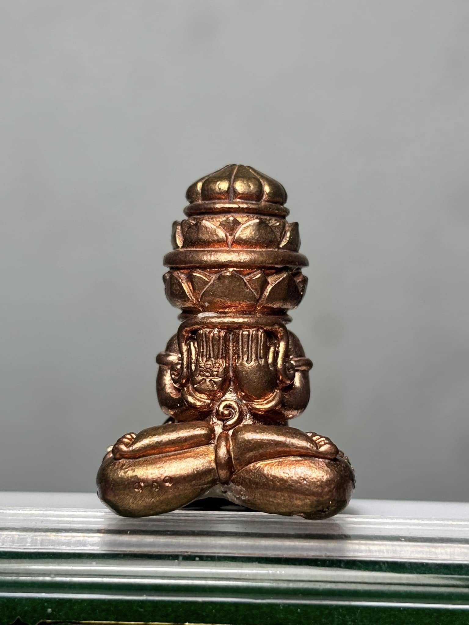 Phang Phakhan amulet for good fortune in bronze finish, featuring intricate detailing and a seated design