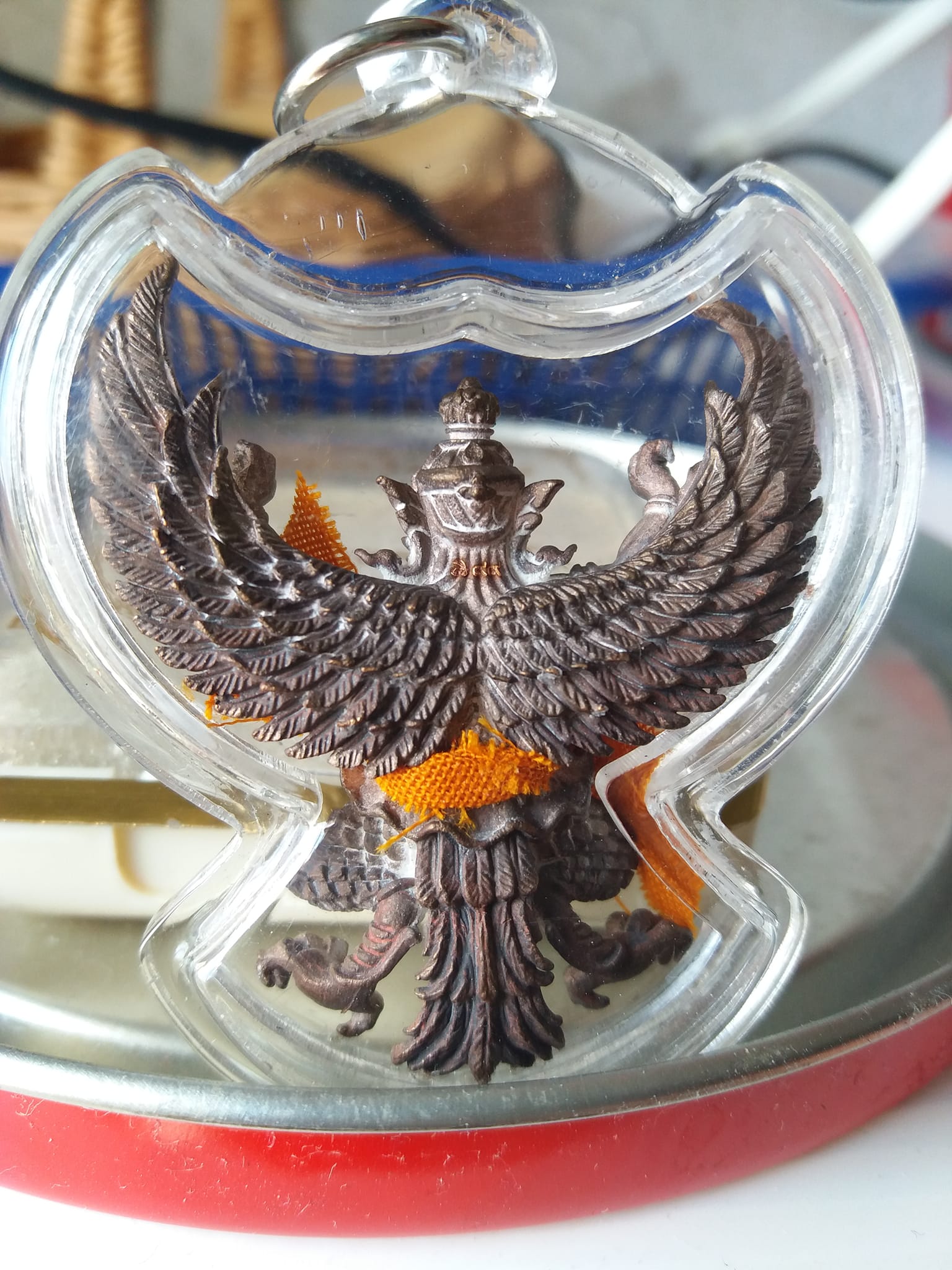 Phaya Garuda amulet for sale in clear protective case showing detailed wings and intricate design