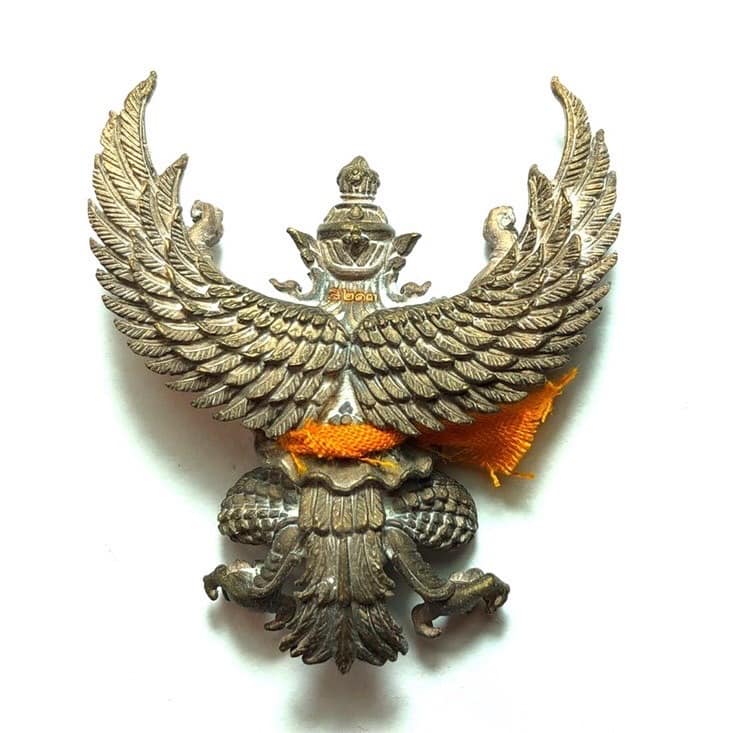 Phaya Garuda amulet for sale by Thai Blessing Co detailed metal bird with spread wings and orange cloth