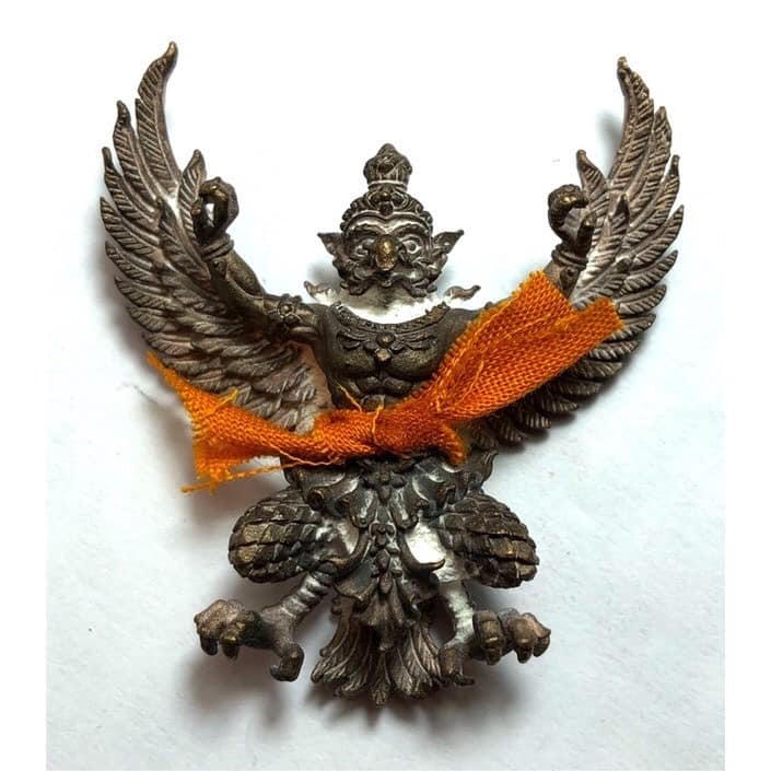 Phaya Garuda amulet for sale from Thai Blessing Co featuring detailed metal craftsmanship with orange cloth