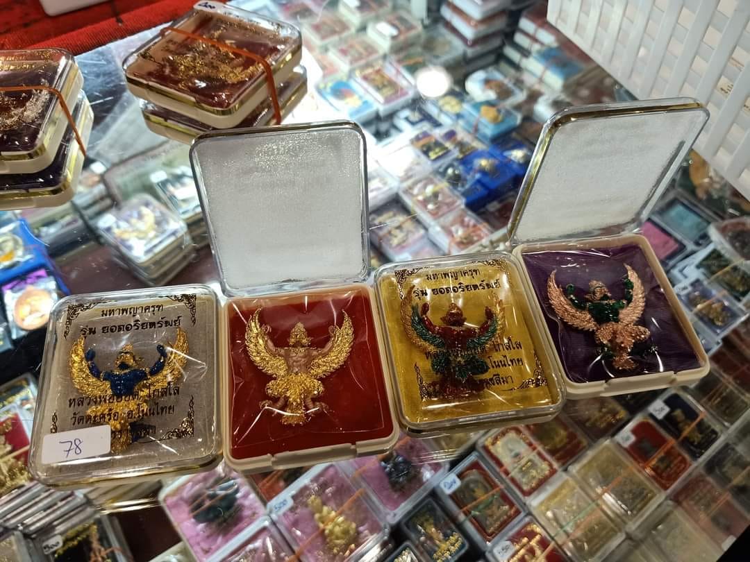 Phaya Garuda amulet for sale displayed in protective cases on glass surface at Thai Blessing Co