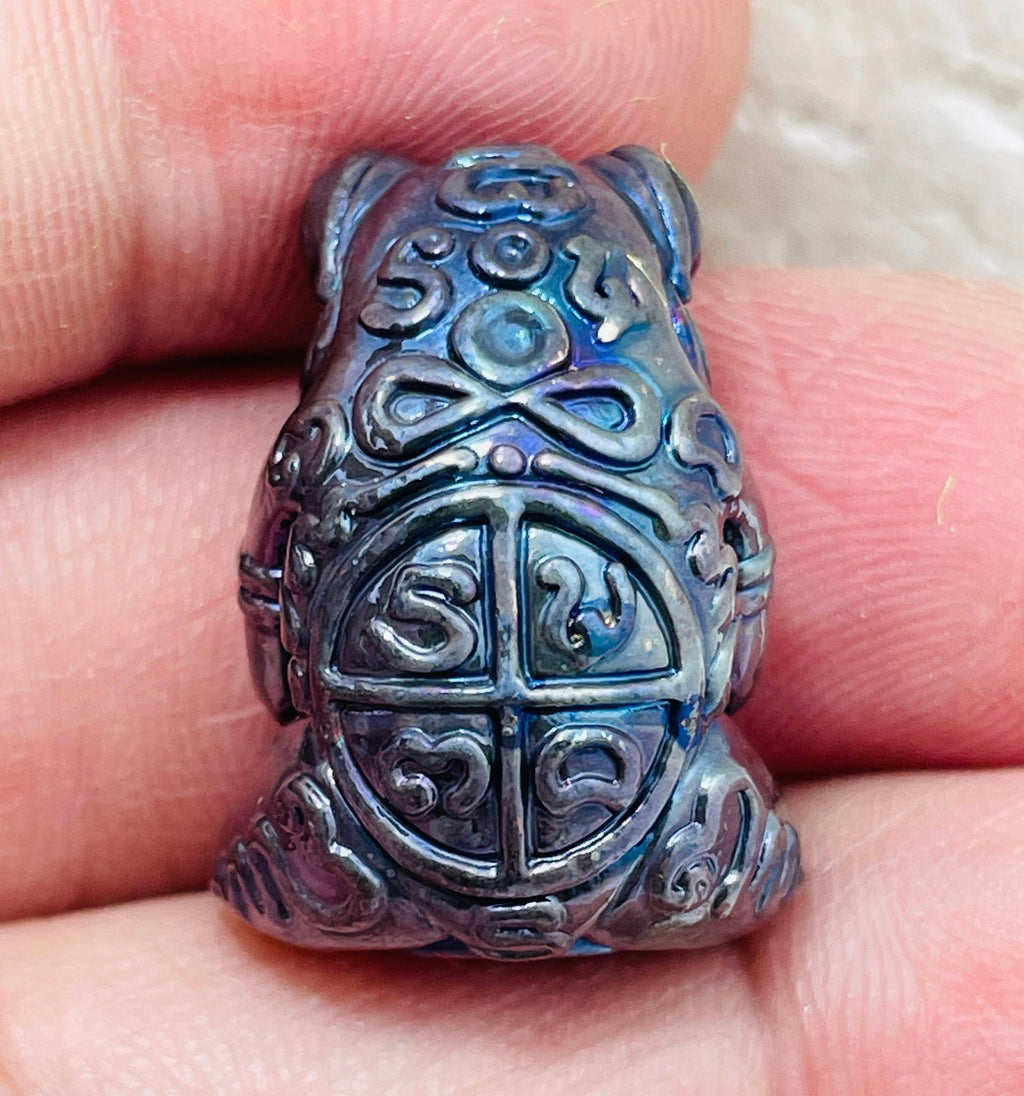 Phaya Kob Kin Duean amulet in a detailed frog design held in hand for good fortune and prosperity