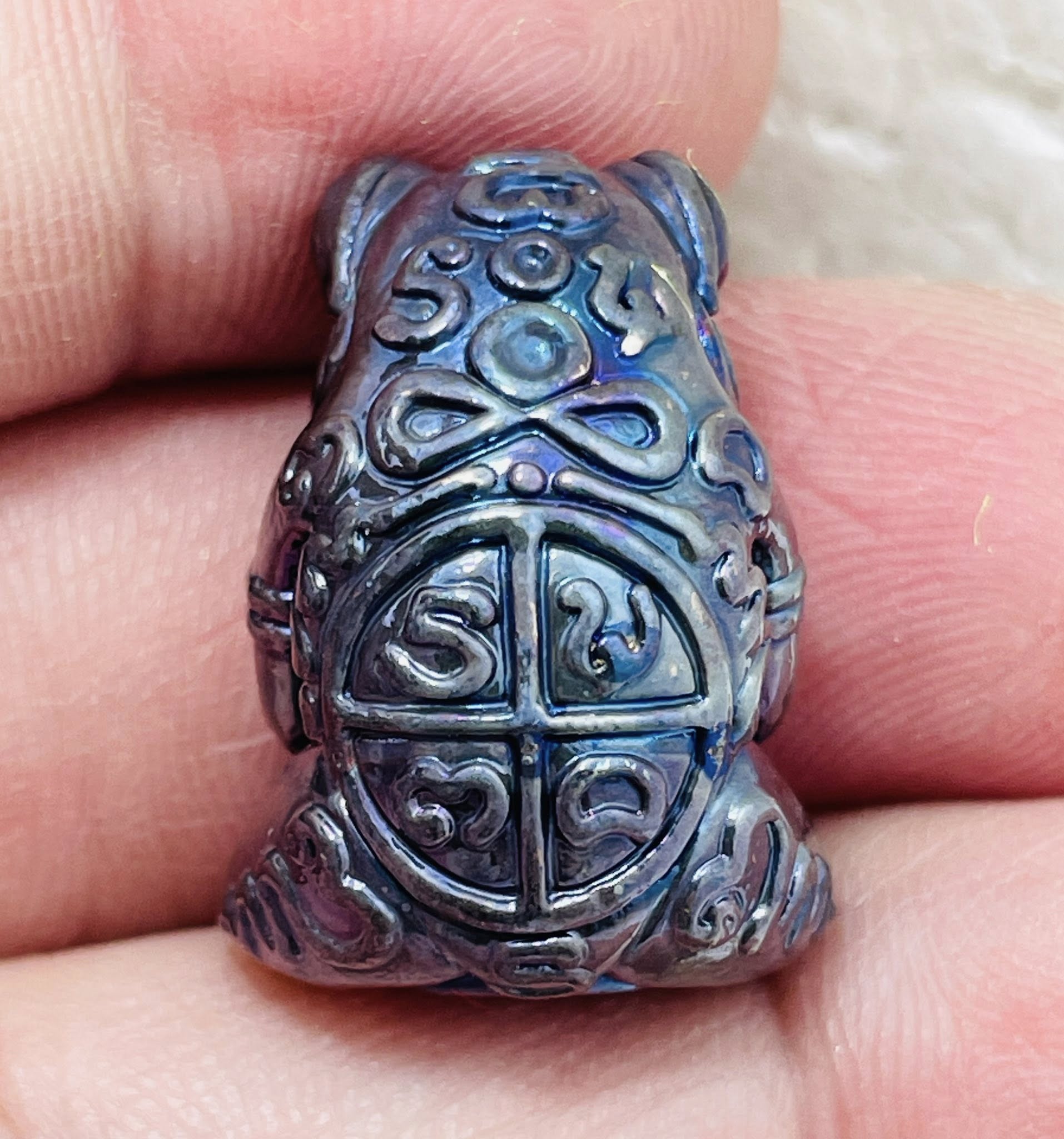Phaya Kob Kin Duean amulet in a detailed frog design held in hand for good fortune and prosperity