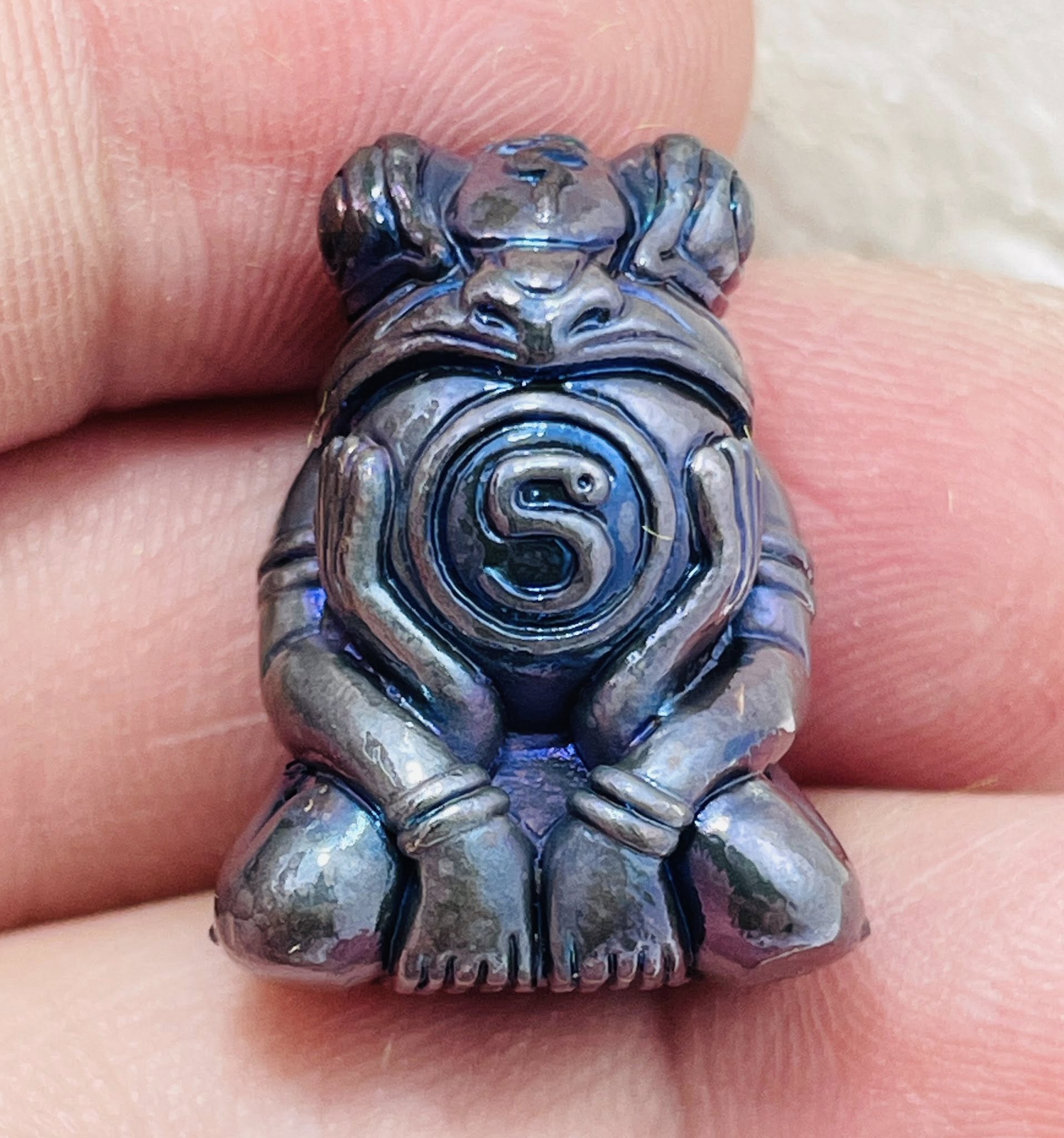 Phaya Kob Kin Duean amulet crafted in silver with intricate detailing and a circular design