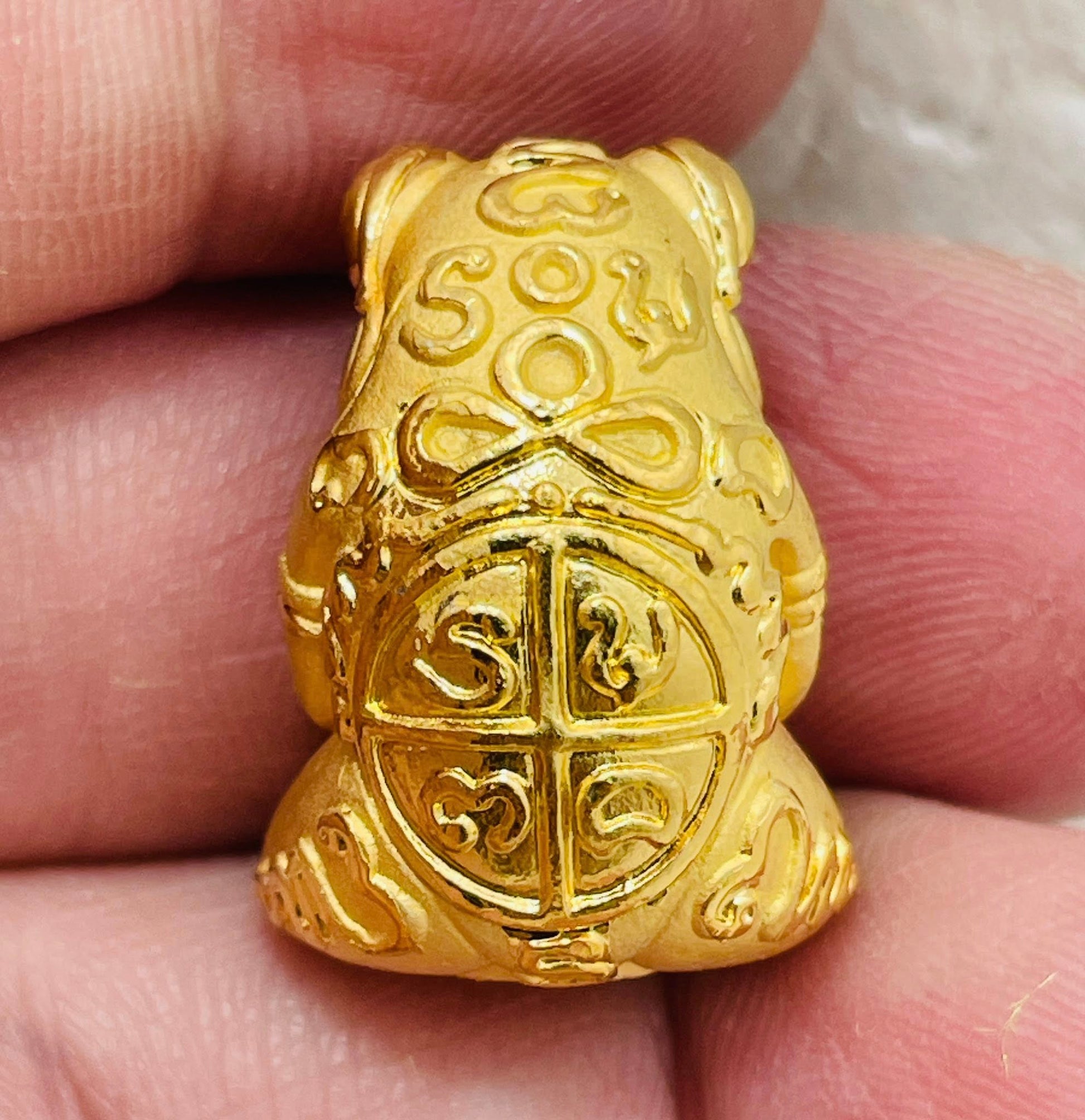 Gold Phaya Kob Kin Duean charm with intricate design and auspicious symbols for good fortune