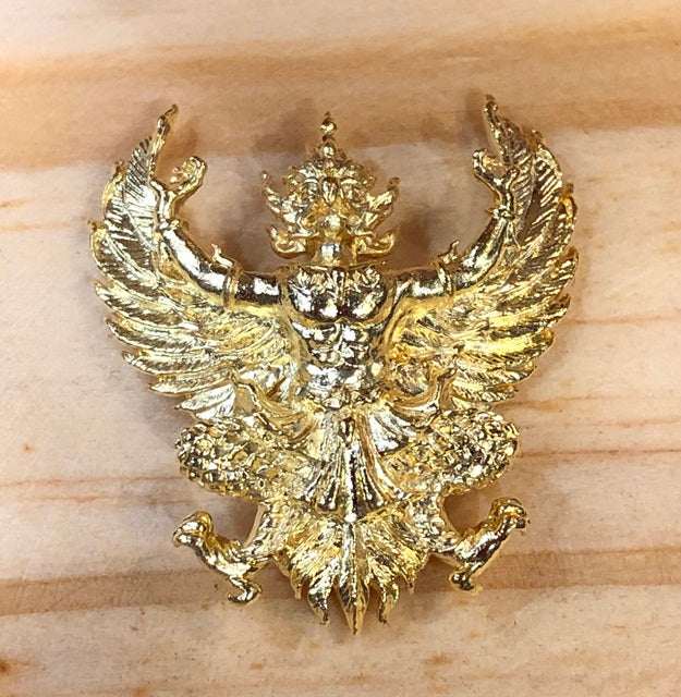 Gold Phaya Krut amulet for wealth and protection with intricate winged creature design