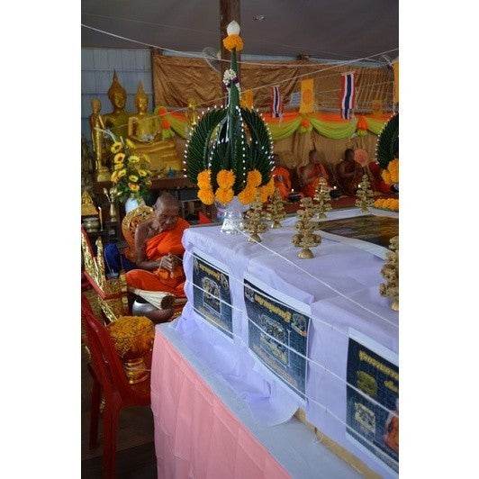 Phaya Moo Setthi sacred pig figurine displayed in a spiritual setting with monks and offerings