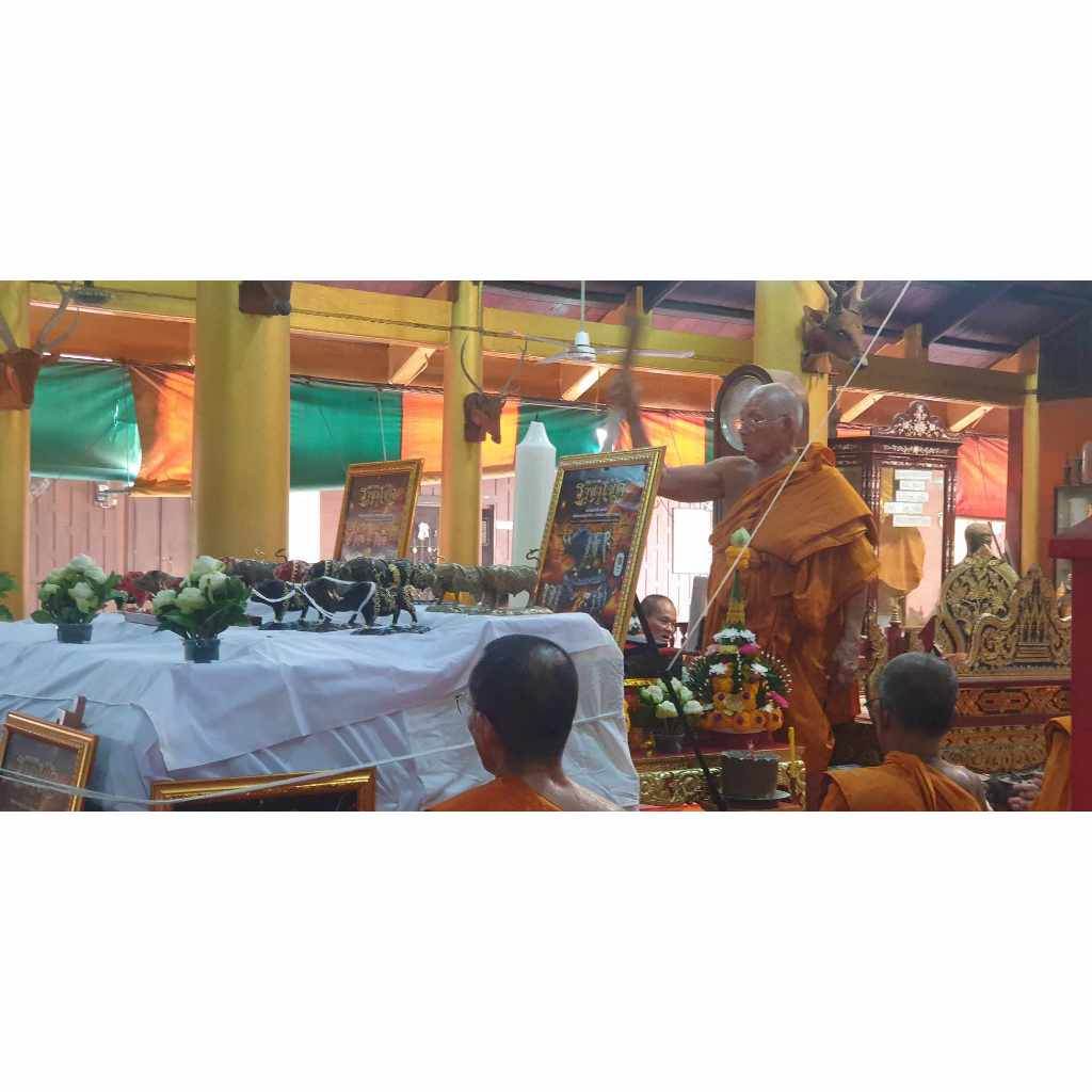 Monk blessing ceremony with Phaya Waraha Racha Chok power talisman displayed on altar and devotees