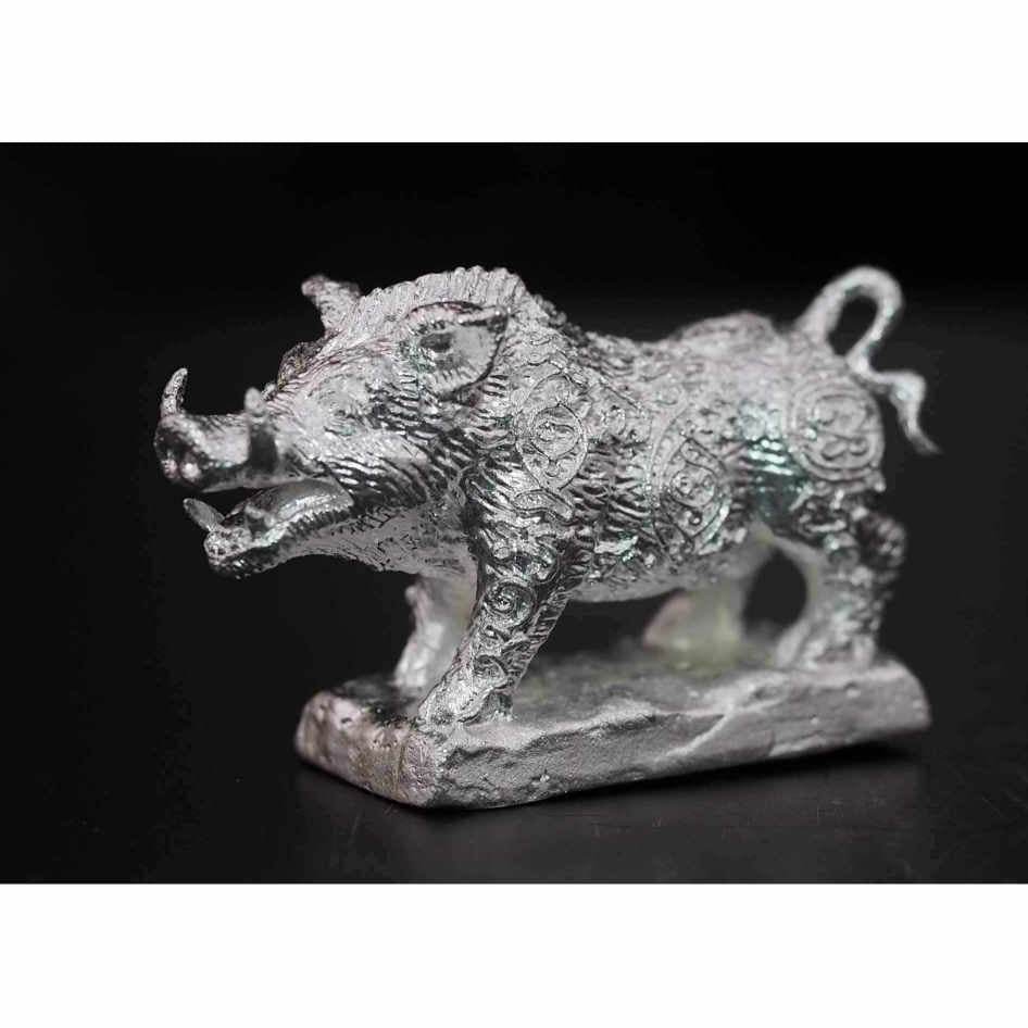 Silver Phaya Waraha wealth charm boar statue with intricate patterns on black background
