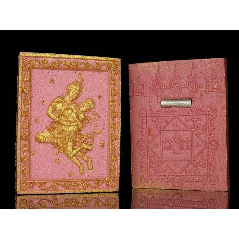 Phet Phaya Thon charm for attraction featuring intricate deity design with golden accents on pink background