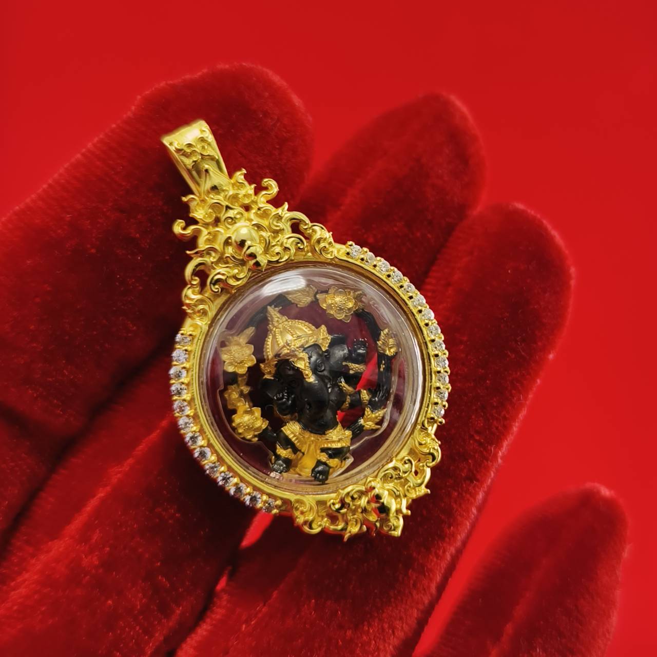 Gold-framed Phra Brahma amulet for protection featuring intricate details and colorful elements