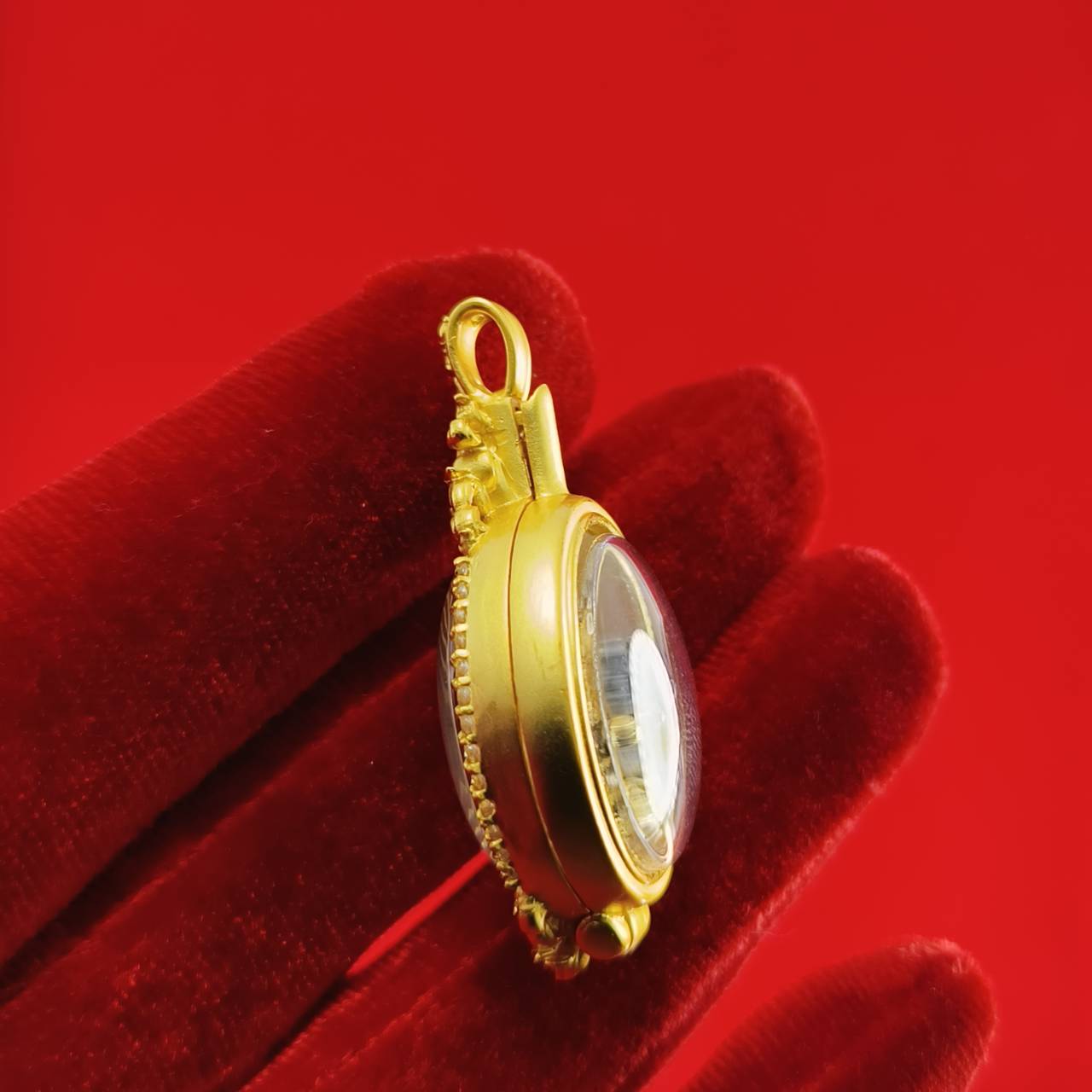 Phra Brahma amulet for protection featuring a gold frame and clear casing for spiritual safety
