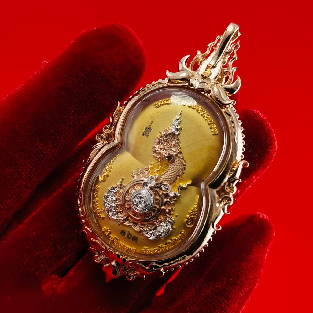 Phra Naga Prok amulet for protection displayed in intricate gold casing with detailed craftsmanship