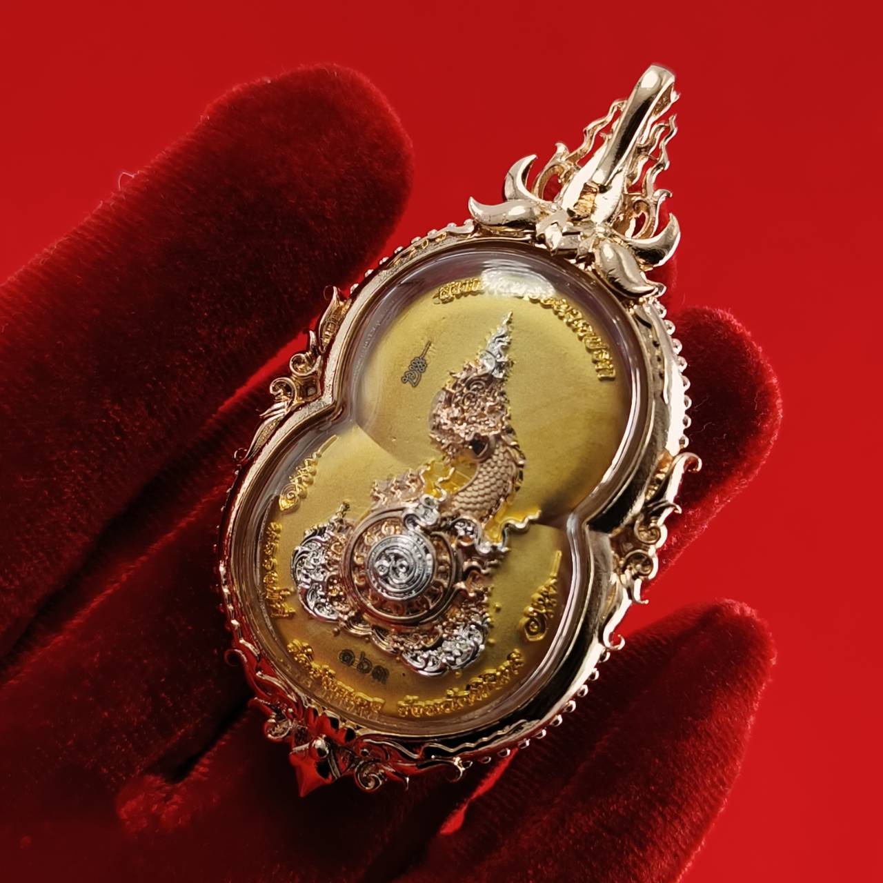 Phra Naga Prok amulet for protection displayed in intricate gold casing with detailed craftsmanship