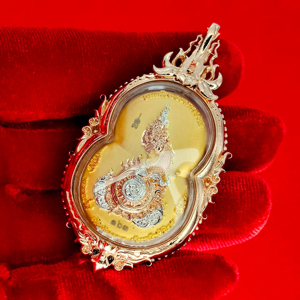 Phra Naga Prok amulet for protection displayed in ornate gold casing on a red background