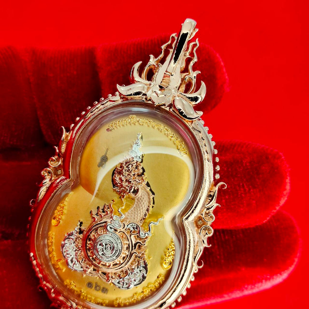 Phra Naga Prok amulet for protection with intricate gold details and a shiny finish