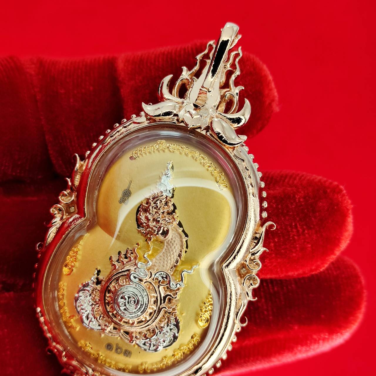 Phra Naga Prok amulet for protection with intricate gold details and a shiny finish