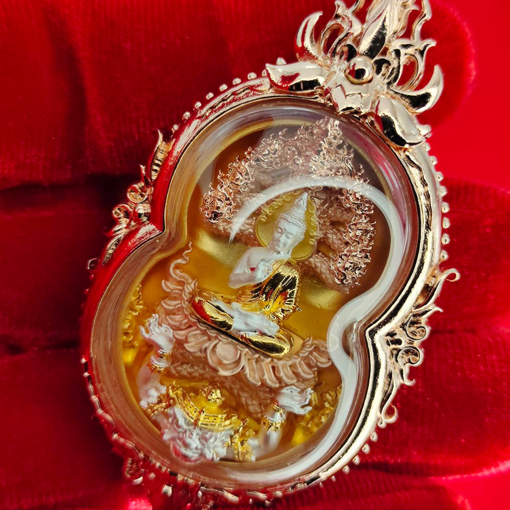 Phra Naga Prok amulet for protection with detailed gold and silver craftsmanship in a protective casing