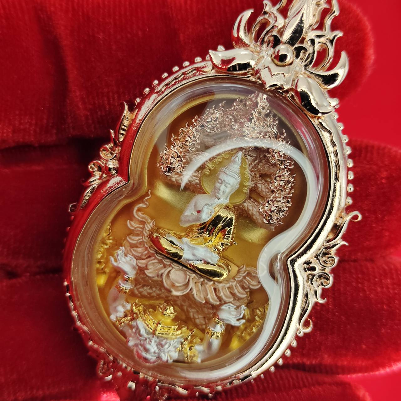 Phra Naga Prok amulet for protection with detailed gold and silver craftsmanship in a protective casing