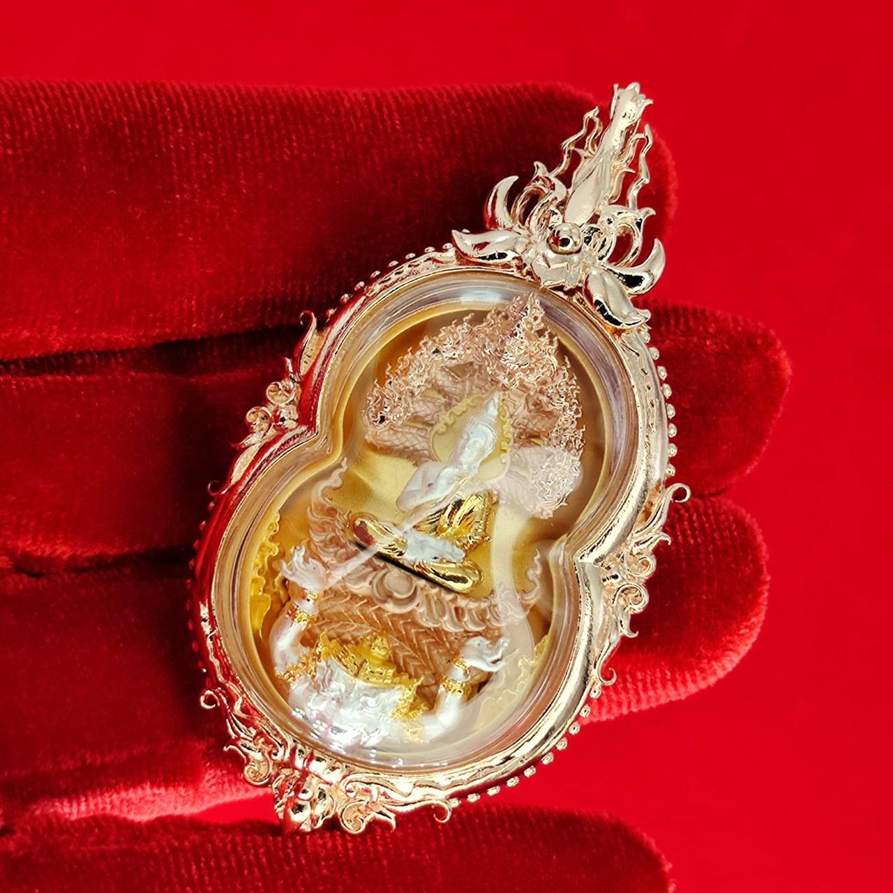 Phra Naga Prok amulet for protection in ornate gold casing with intricate details and a spiritual design