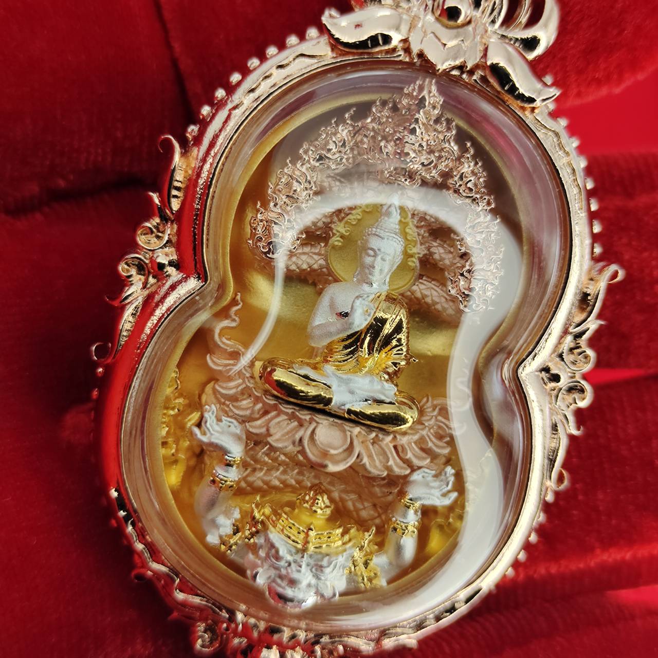Intricate Phra Naga Prok amulet for protection featuring a seated Buddha and ornate detailing