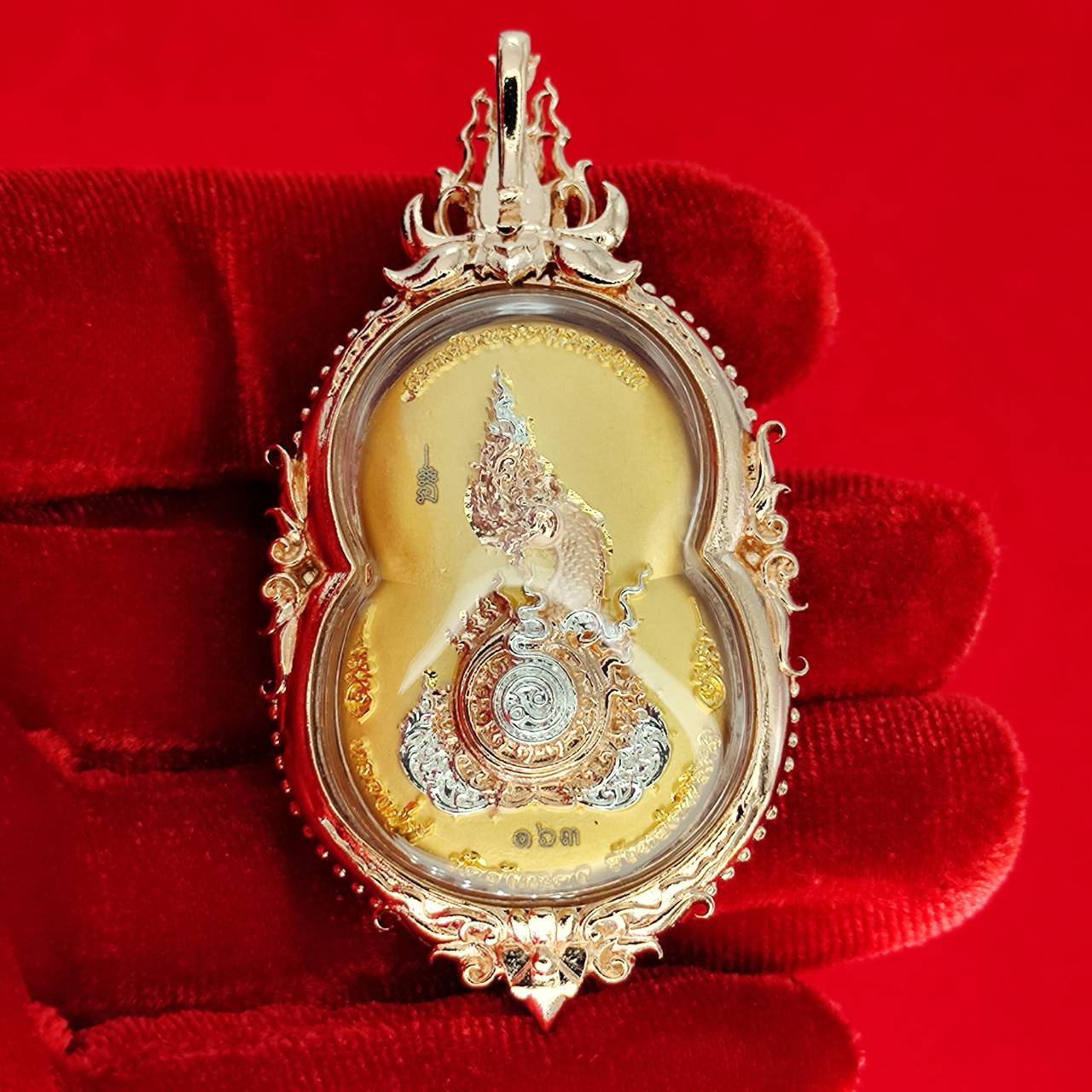 Phra Naga Prok amulet for protection in ornate gold casing with intricate design and vivid details