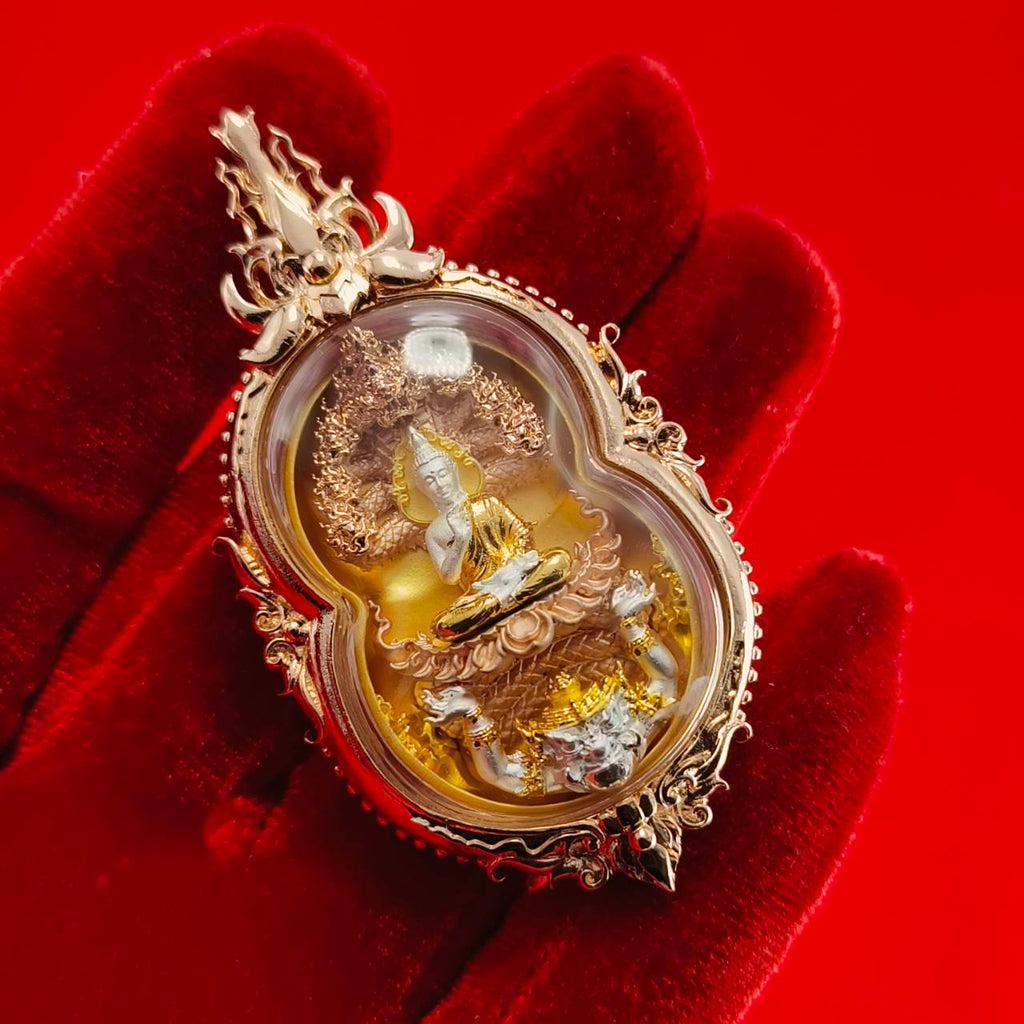Phra Naga Prok amulet for protection beautifully crafted in a gold frame depicting a serene Buddha figure.