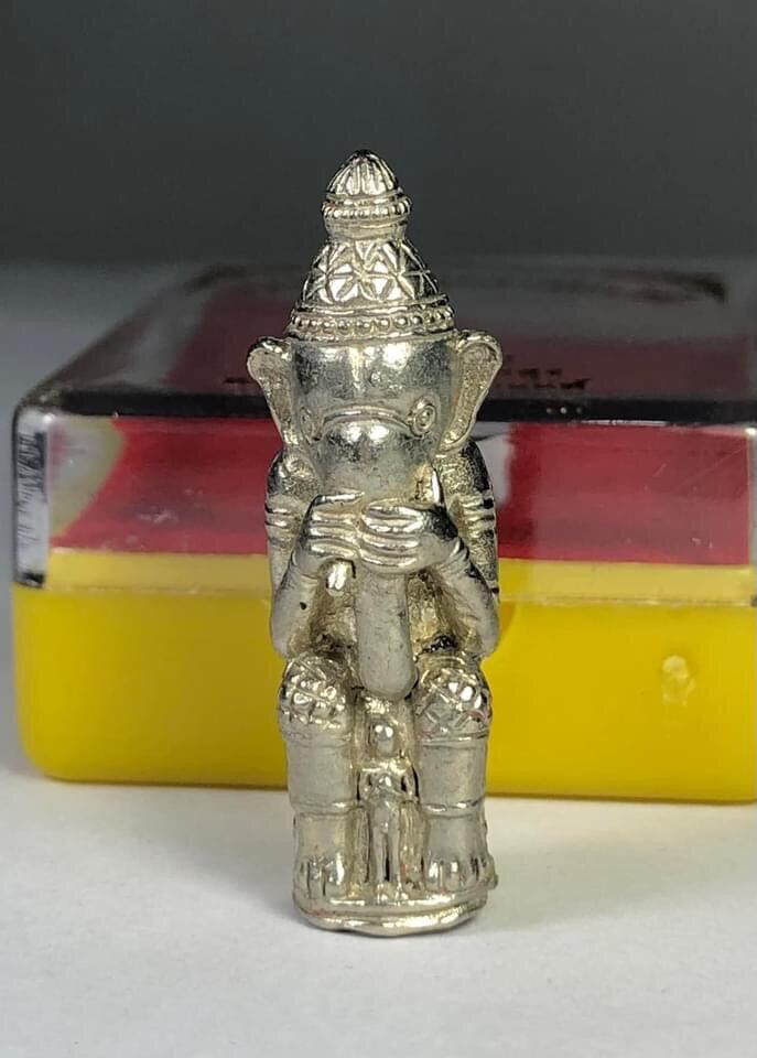 Silver Phra Phikanet amulet for blessing with intricate traditional design on display