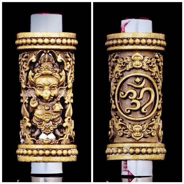 Phra Phikanet Takrud amulet featuring intricate gold carvings and sacred symbols for protection.