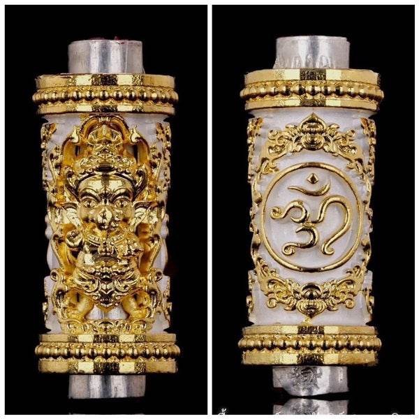 Phra Phikanet Takrud amulet with intricate gold detailing and ornate designs on both sides