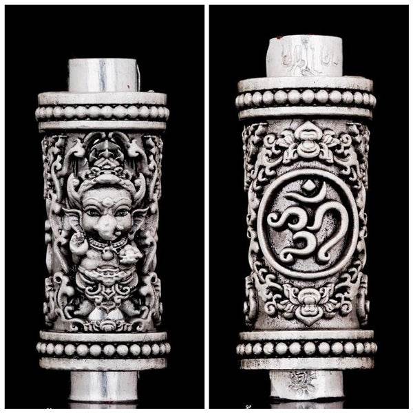 Handcrafted Phra Phikanet Takrud amulet with intricate designs and spiritual symbols on silver finish