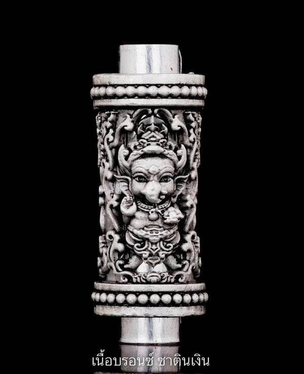 Detailed Phra Phikanet Takrud amulet with intricate carvings showcasing traditional designs and spiritual symbols