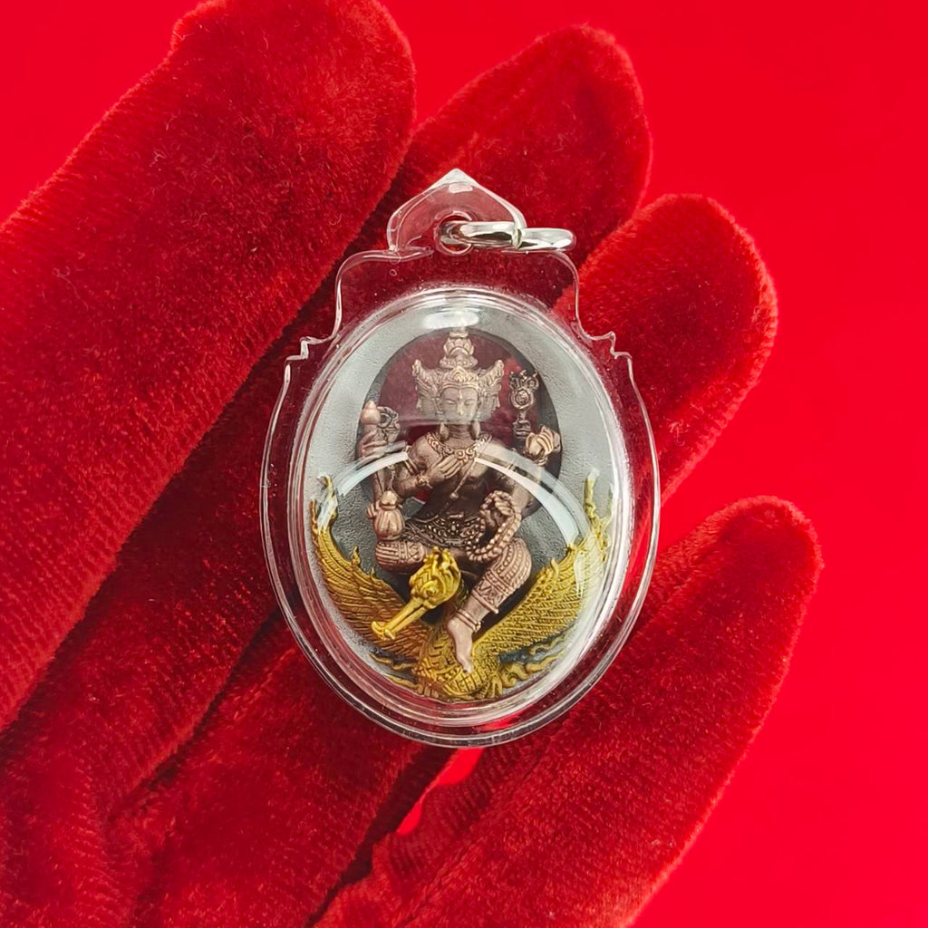 Phra Phrom Thai amulet featuring a detailed deity figure with vibrant colors encased in transparent protection.