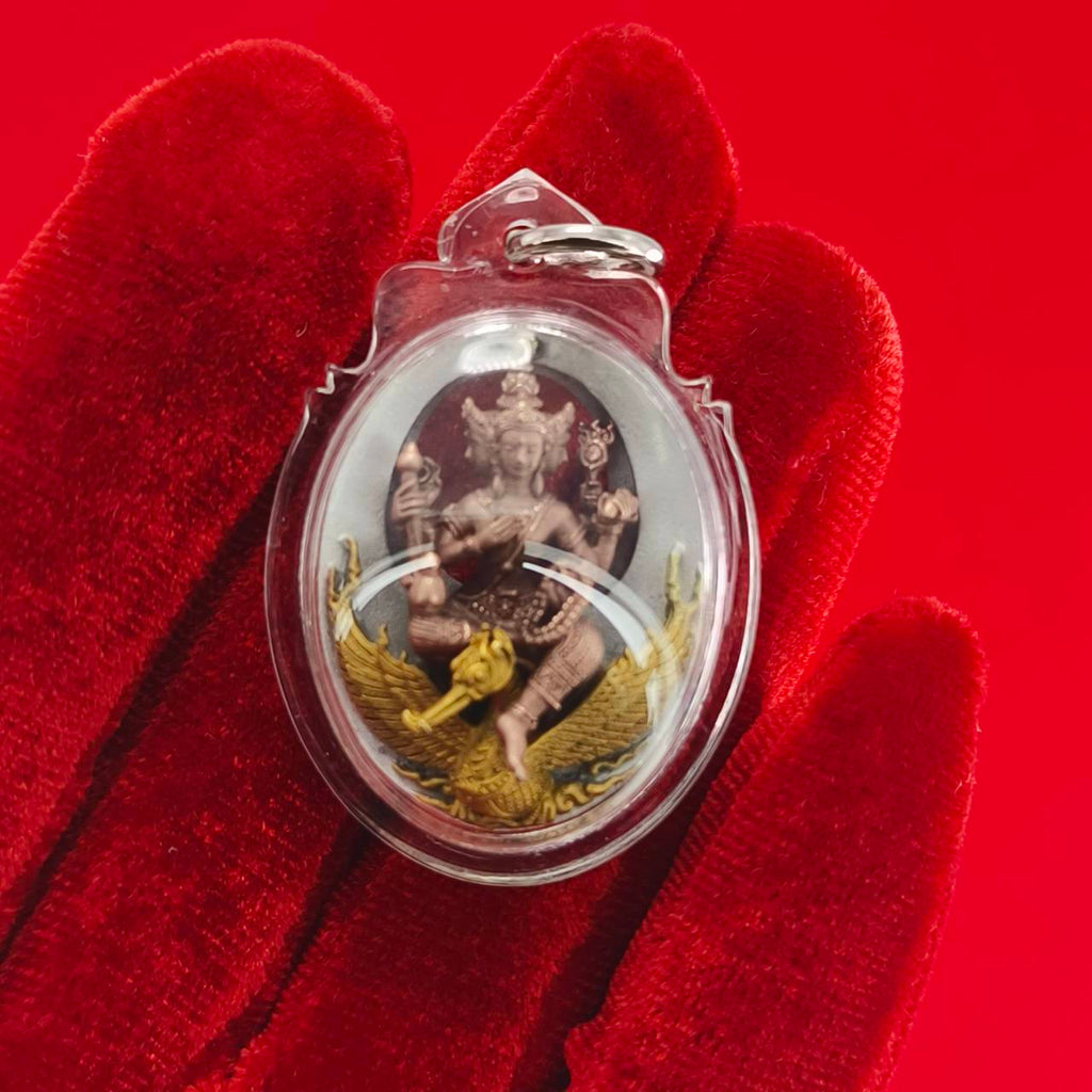Phra Phrom Thai amulet encased in clear plastic with intricate details and vibrant colors for spiritual protection