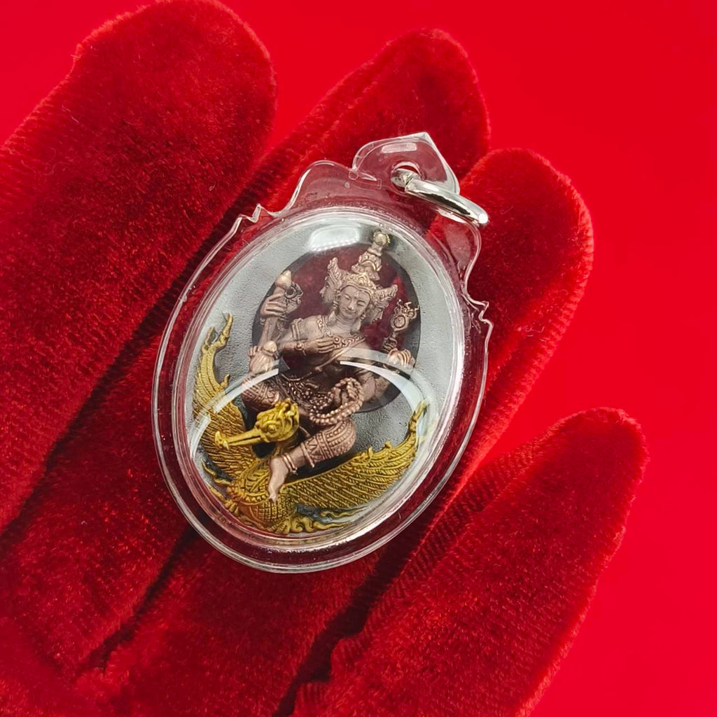 Phra Phrom Thai amulet encased in clear plastic, depicting the deity with intricate detailing