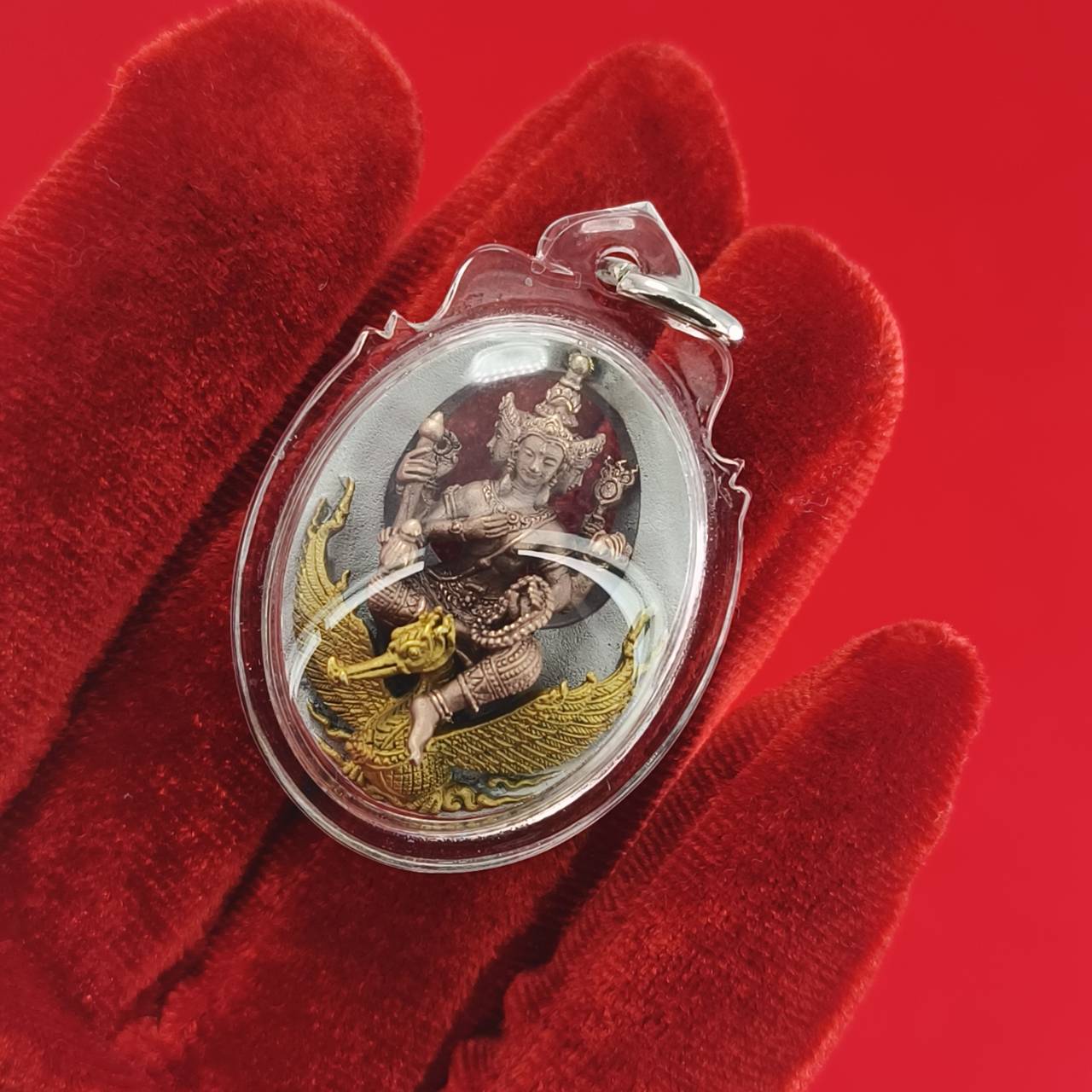 Phra Phrom Thai amulet encased in clear plastic, depicting the deity with intricate detailing