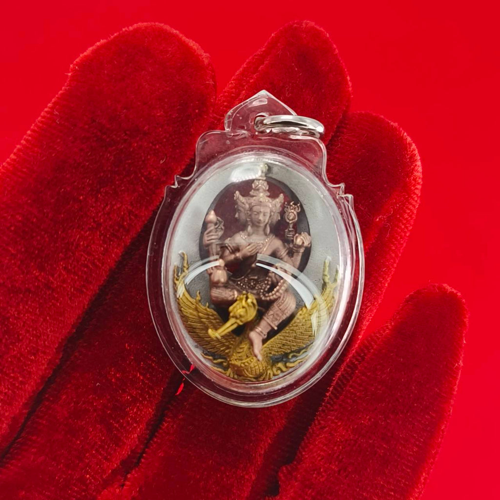 Phra Phrom Thai amulet encased in clear plastic with a gold base and intricate details